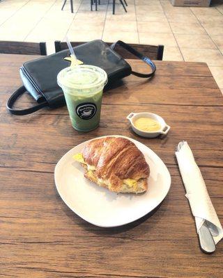 Egg and Cheese Croissant with Iced Matcha Latte with Lavender and Honey.