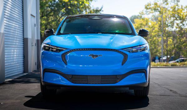 Mustang Mach-E protected with a front end DYNOshield PPF, preserving its metallic blue from the elements out on the road!