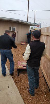 Playing Cornhole on the outdoor patio area.