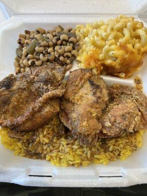 Fried pork chop, rice with gravy, blackened peas, and macaroni and cheese!!!!!