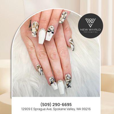 Marble white nails with charming accents for a look that's both sophisticated and dazzling.