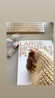 Rounded acrylic nails with neon yellow French tips.