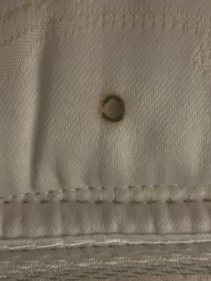 Cigarette burn on mattress in a non smoking room