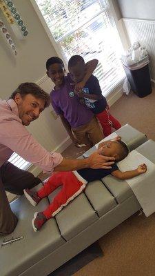 Dr Fuller taking care of some cute kids in the office!