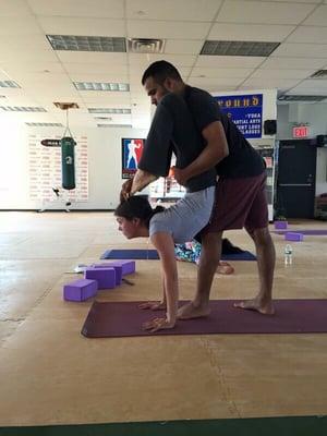 Amit helping his student with the scorpion pose