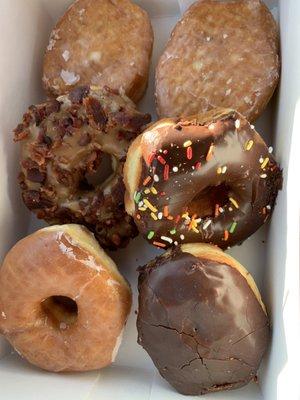 Top: Filled raspberry and lemon  Middle: Maple bacon and chocolate sprinkled  Bottom: Plain glazed and Boston cream