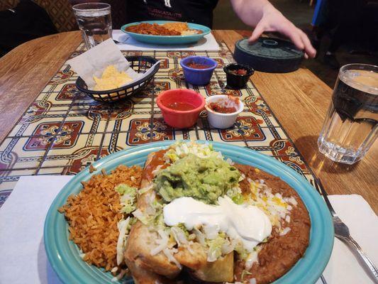 Chimichanga lunch with Chile Colorado in the background.