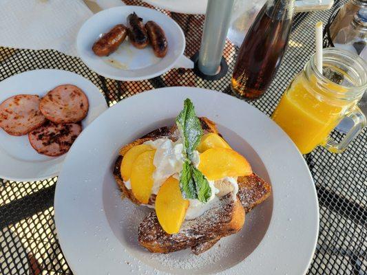 French toast with vanilla and honey marscapone, whipped cream, and peaches, Canadian bacon, sausage.