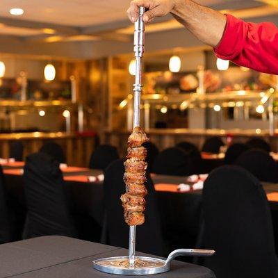 12 different types of meat which are presented on skewers and carved table side. www.cafemineirosteakhouse.com