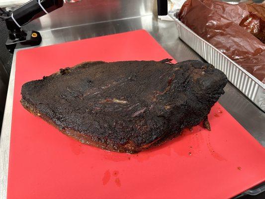 Smoked brisket getting ready to slice for service