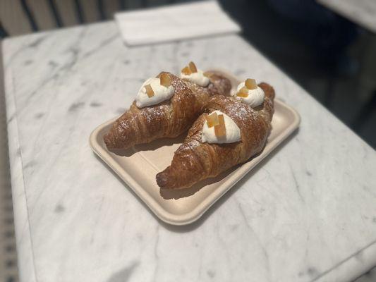 Freshly baked croissants with ricotta filling normally used in cannoli.