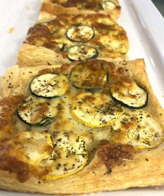 Zucchini and squash, cheddar on our puff pastry.