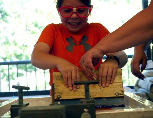 DIY! At camp we create our own band logos and screenprint our own band shirts!