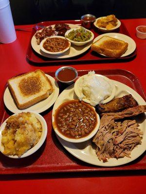 Peach Cobbler, Baked Beans, Mashed Potatoes, Pulled Pork and Ribs.