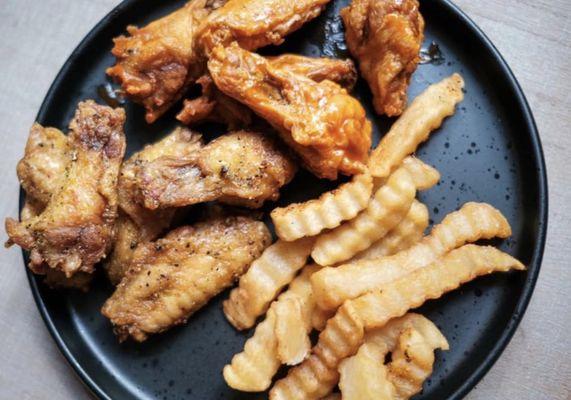 Hot buffalo wings and lemon pepper wings with fries