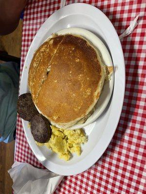 Breakfast sampler, hot cakes, scrambled eggs, sausage.