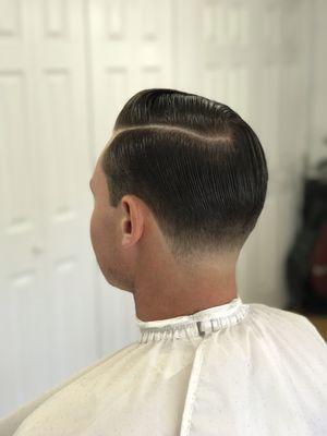 Classic Pompadour with a tapered neck line.