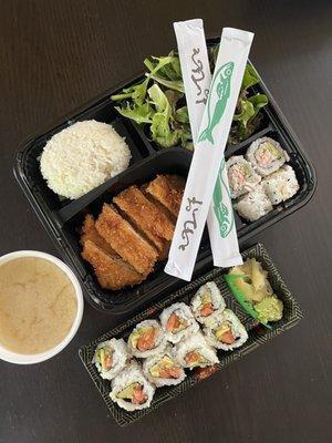 Lunch bento box with a side of sushi