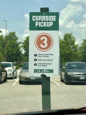 Curbside pick up spots located in car park near store front