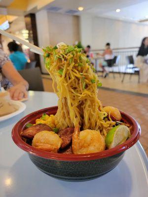 Flying house noodles with shrimp, sausage, and lime.  Get the chili sauce in container on side to add to your preference!