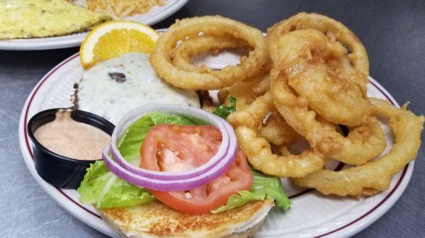 A delicious burger with our homemade onion rings!