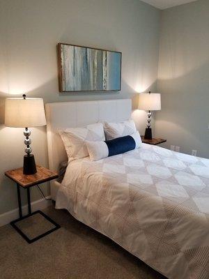 A staged Guest bedroom by Amethyst Interiors, light airy and peaceful color pallet.