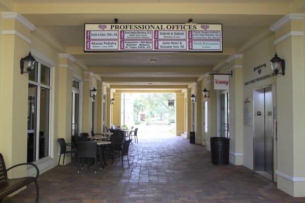 Breezeway, elevator to Law Office of Gabriel & Gabriel is located to right of sign.