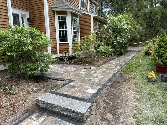 New walkway with a granite step leading into second walkway