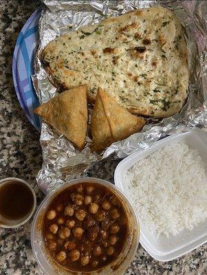 Garlic naan (2), samosas (2), chana masala comes with side of white rice.