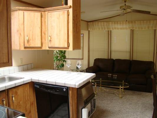 Furnished with new sofa. Note the dishwasher and tile counter tops.