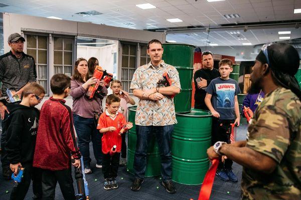 Players of all ages gear up for adventure at Tactical Urban Combat. Excitement awaits around every corner