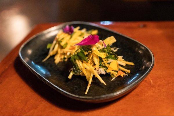 Gỏi Xoài - green mango salad, rau ram, cilantro, thai basil, mint, cashews, fried shallots, bortarga, puffed black sesame rice cracker