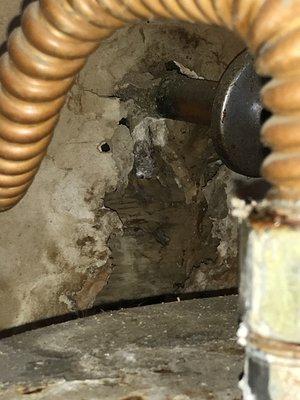 Stalactite formed from a long-term water heater leak. Considerable damage to surroundings.