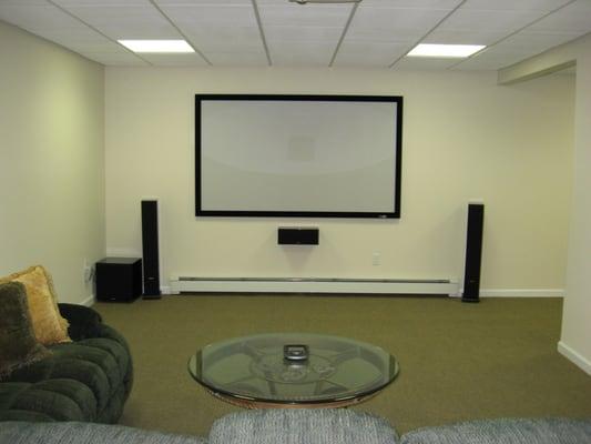 This front projection home theater used floor standing front speakers and in ceiling side and rear speakers for a 7.1 surroun...