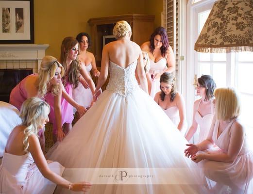 Bride getting ready with a little help from her bridesmaids in Los Angeles.