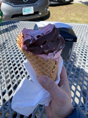 Cherry soft serve dipped in chocolate in waffle cone.