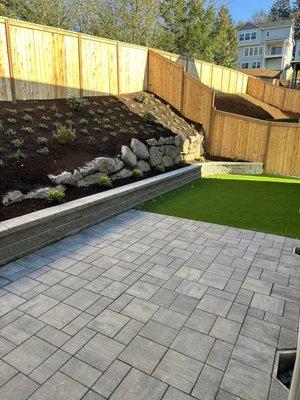 Pavers, plants, retaining wall and Faux Grass