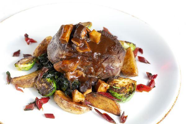 FILETTO MANZO AI FUNGHI with 8 oz. Beef tenderloin, mushroom and demi sauce, roasted potatoes, Brussels sprouts & red chard