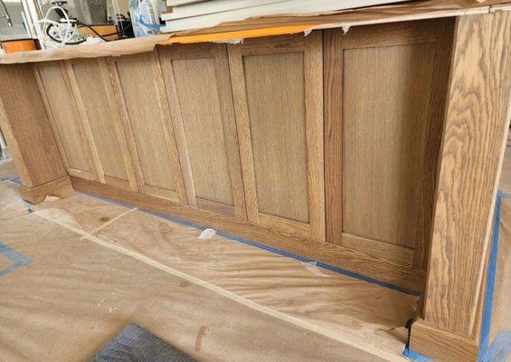 Uneven and blotchy stain variation in the kitchen island caused by Kaiser's cabinet maker.