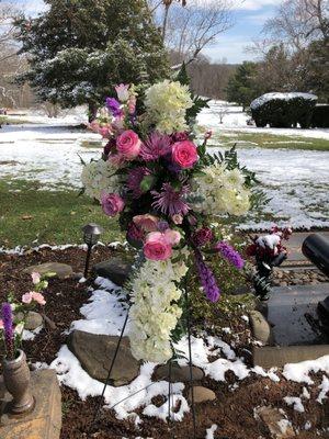 Standing spray in the shape of a cross, for the funeral in December 2021 (With snow on the ground)