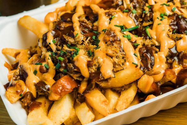 Angry Fries with in-house smoked pulled pork, bayou sauce, bbq, and chives