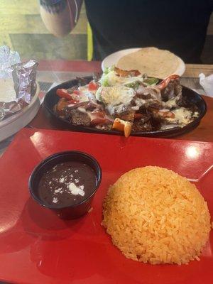 Steak fajitas - come with tortillas and side of yellow rice and black beans.