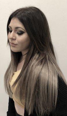 Ombré hair color, micro bead hair extensions and makeup.