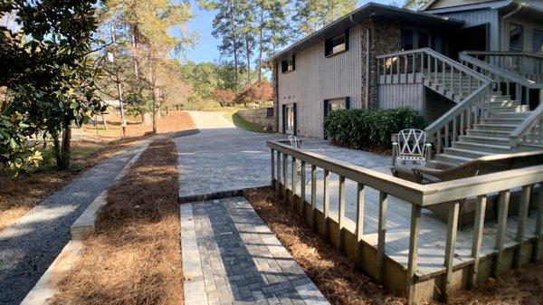 Paver sidewalk, driveway, gravel side drive.