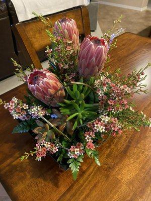 Beautiful arrangement of proteas and succulents!