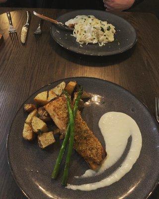 Salmon with roasted potatoes and asparagus (front) and chicken Alfredo (back)