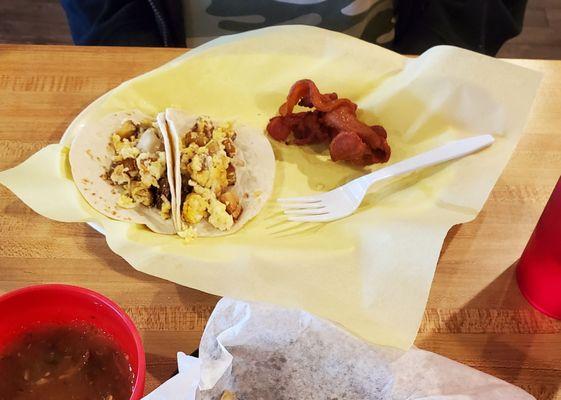 Potato and cheese breakfast tacos with a side of bacon.