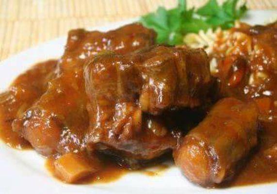 Stewed oxtail served with a choice of rice and side order