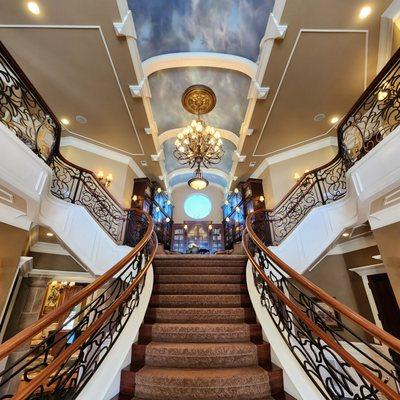 Grand entrance staircase, with library at top and hand painted ceiling --- Beautiful!