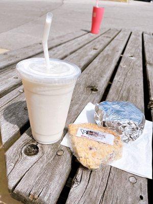 Pineapple colada smoothie! Orange cranberry scone and breakfast sandwich